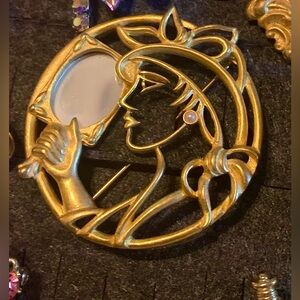 Vintage lady looking in mirror brooch